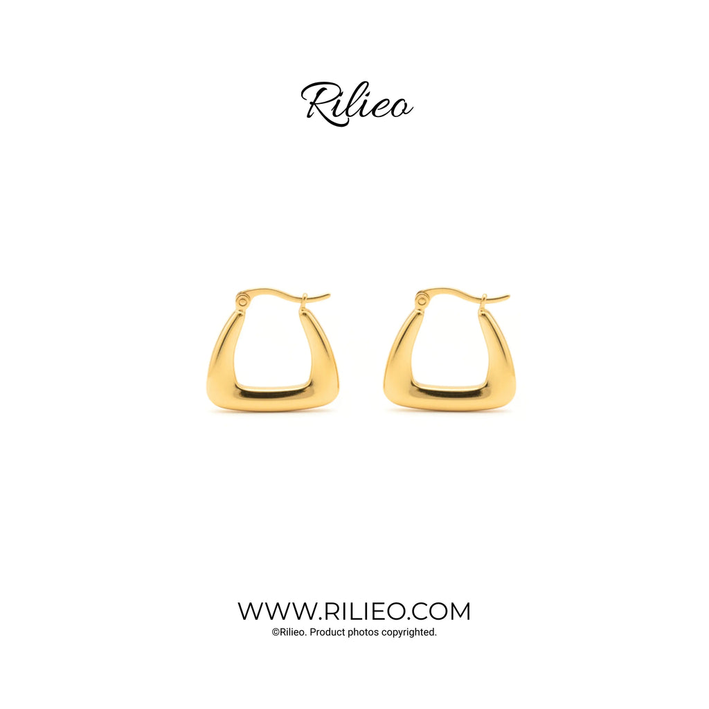 Pair of modern gold plated geometric hoop earrings on white background