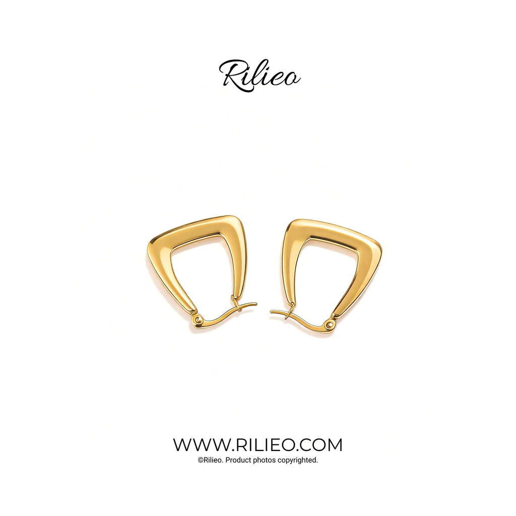 Pair of modern geometric gold plated earrings on a white background