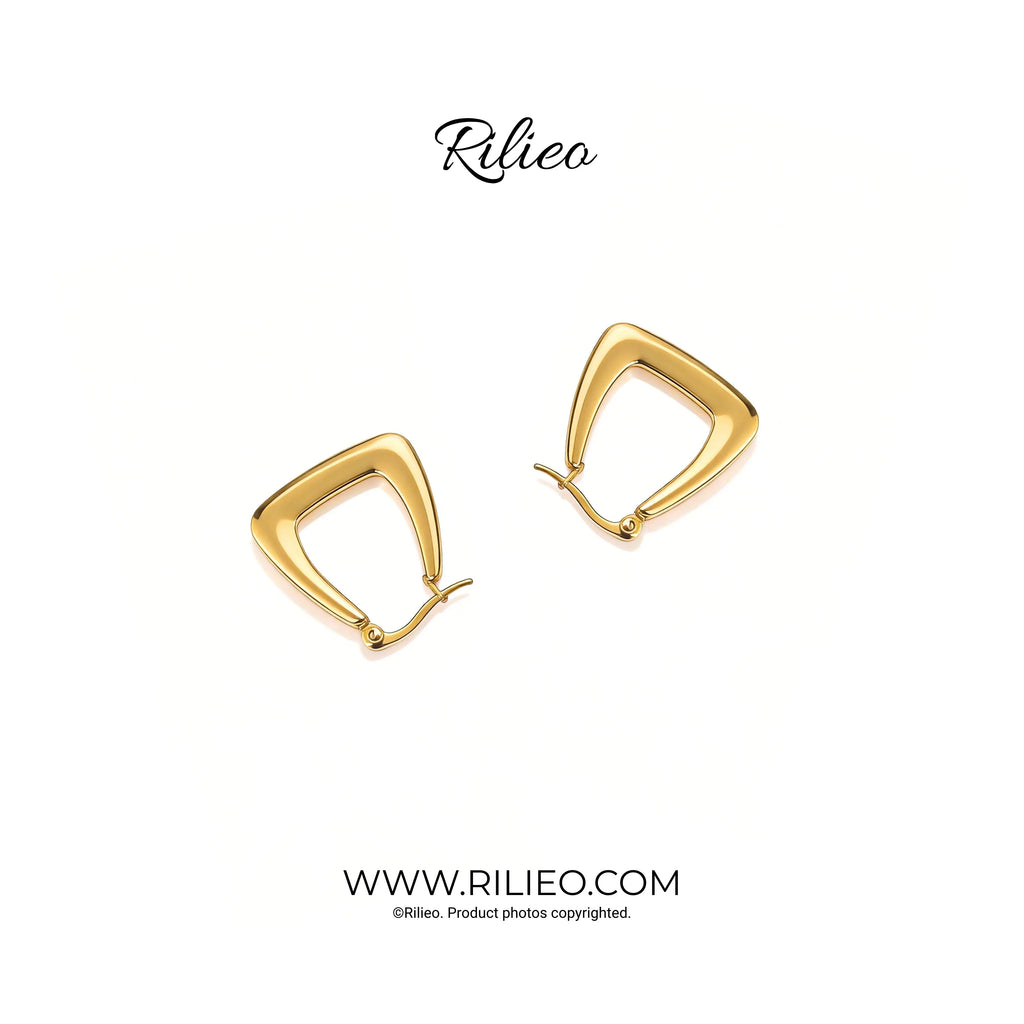 Modern gold plated geometric earrings with a triangular shape on a white background