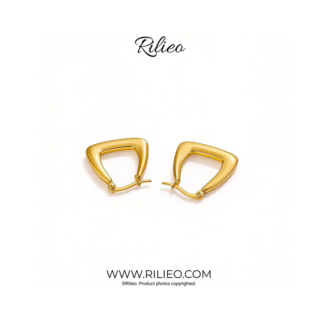 Modern gold plated geometric earrings on a white background